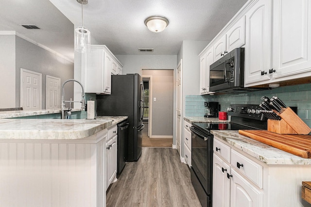 303 Valley View Ct, Rio Vista, TX 76093 - kitchen featuring light wood-style flooring, white cabinetry, black appliances, and visible vents