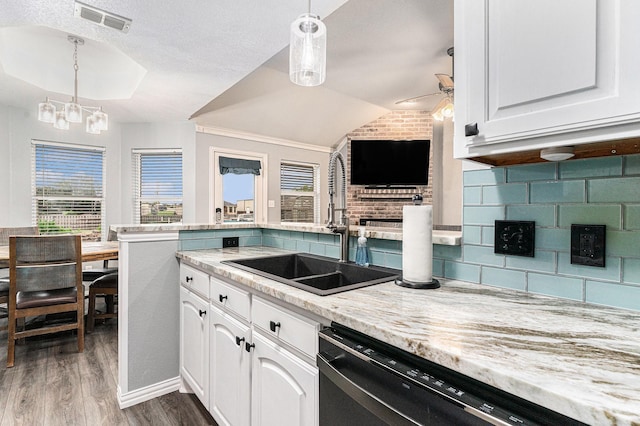 303 Valley View Ct, Rio Vista, TX 76093 - kitchen with lofted ceiling, dishwasher, visible vents, a sink, and wood finished floors