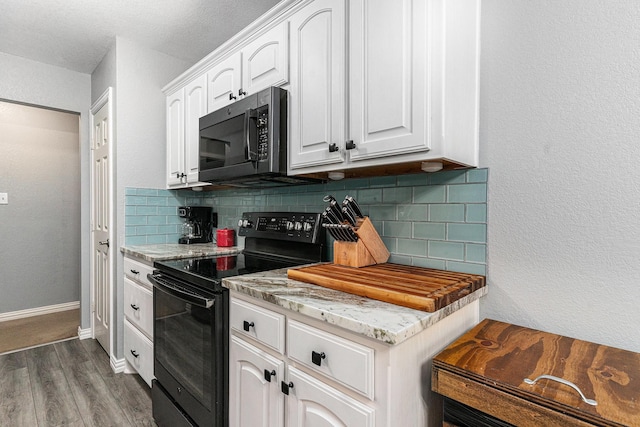 303 Valley View Ct, Rio Vista, TX 76093 - kitchen featuring black range with electric cooktop, dark wood finished floors, white cabinetry, decorative backsplash, and light stone counters