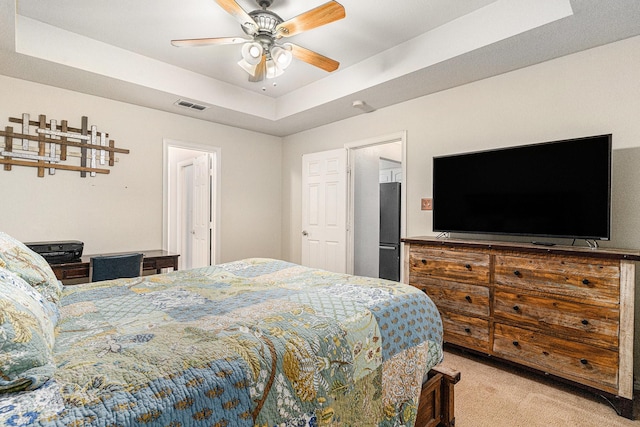 303 Valley View Ct, Rio Vista, TX 76093 - bedroom with visible vents, a raised ceiling, ceiling fan, light carpet, and fridge
