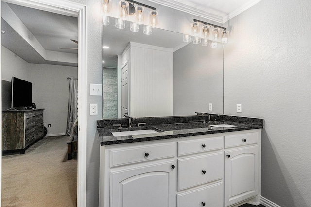 303 Valley View Ct, Rio Vista, TX 76093 - bathroom featuring double vanity, crown molding, baseboards, and a sink