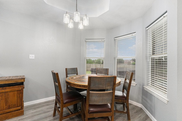 303 Valley View Ct, Rio Vista, TX 76093 - dining room featuring baseboards, an inviting chandelier, and wood finished floors