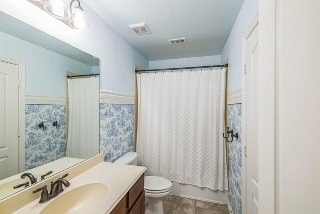 bathroom with toilet, tile patterned floors, visible vents, and vanity