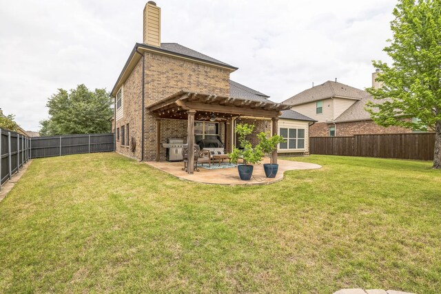 back of house with a pergola, brick siding, a fenced backyard, a patio, and a yard