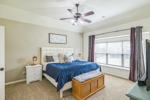 bedroom featuring baseboards, light carpet, and ceiling fan