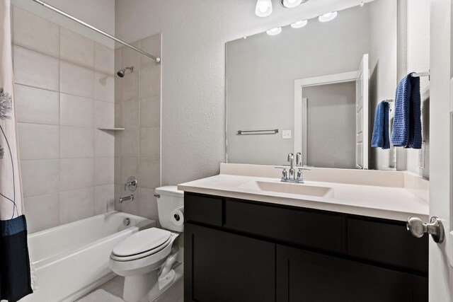 full bath with vanity, a textured wall, toilet, and shower / bathtub combination with curtain