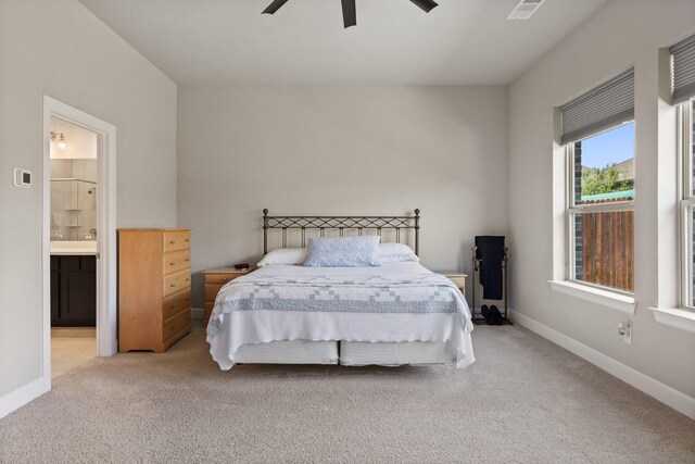 bedroom featuring baseboards, ensuite bathroom, carpet flooring, and visible vents