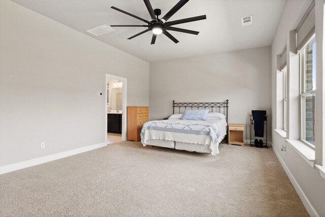 bedroom with baseboards, visible vents, and light carpet