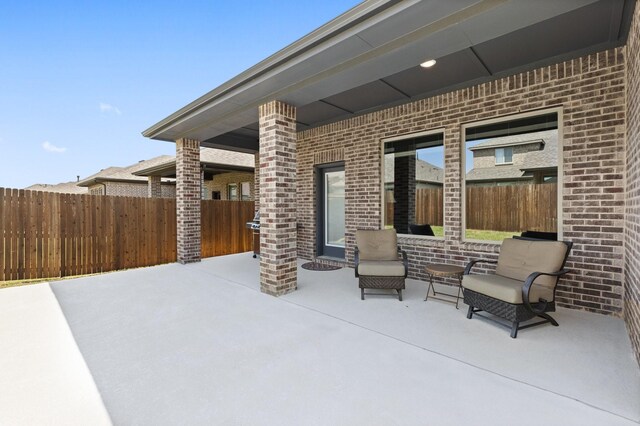 view of patio featuring fence