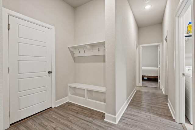 mudroom with baseboards and wood finished floors