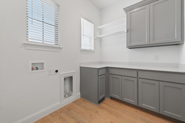 149 Highgate Ct, Boyd, TX 76023 - washroom featuring cabinet space, hookup for a washing machine, light wood-style flooring, baseboards, and hookup for an electric dryer