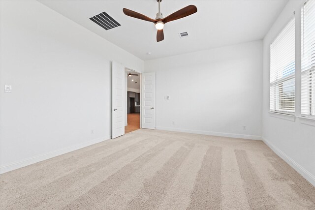 149 Highgate Ct, Boyd, TX 76023 - empty room featuring visible vents, baseboards, ceiling fan, and light carpet