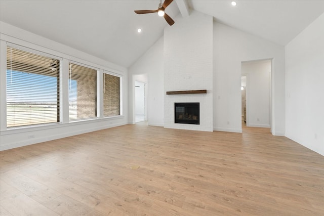 149 Highgate Ct, Boyd, TX 76023 - unfurnished living room with ceiling fan, a brick fireplace, high vaulted ceiling, baseboards, and light wood-style flooring