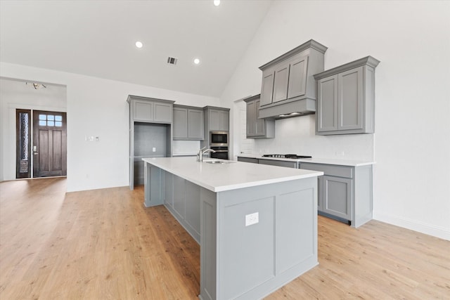 149 Highgate Ct, Boyd, TX 76023 - kitchen with gas cooktop, gray cabinets, stainless steel microwave, and a sink