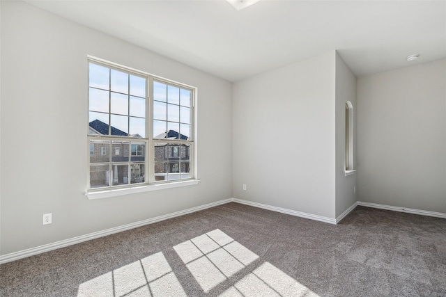 carpeted spare room with baseboards