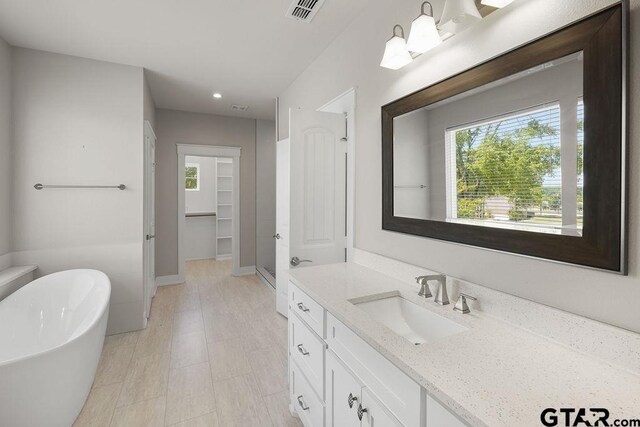 12090 Hackberry Holw, Tyler, TX 75706 - full bathroom featuring vanity, recessed lighting, a freestanding tub, visible vents, and a stall shower