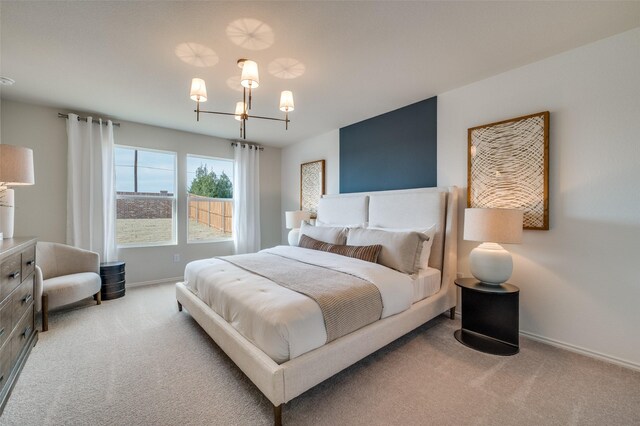 bedroom featuring baseboards, carpet flooring, and a notable chandelier