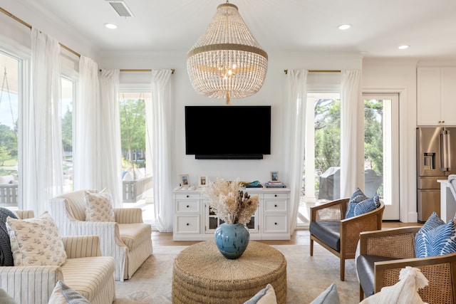 living room featuring recessed lighting, a chandelier, light wood-style flooring, and visible vents