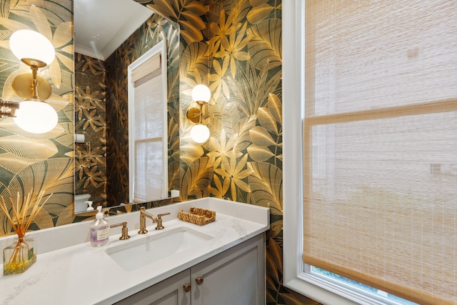bathroom with vanity and wallpapered walls