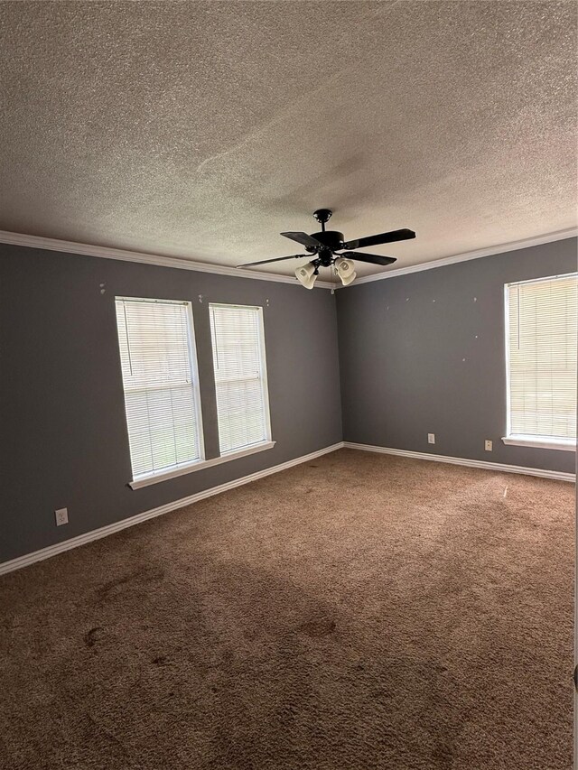 carpeted empty room with crown molding, a textured ceiling, ceiling fan, and baseboards