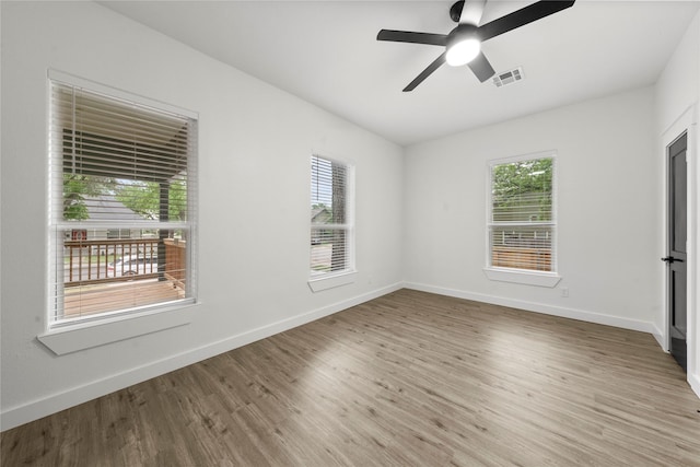unfurnished bedroom featuring ceiling fan, baseboards, visible vents, and wood finished floors
