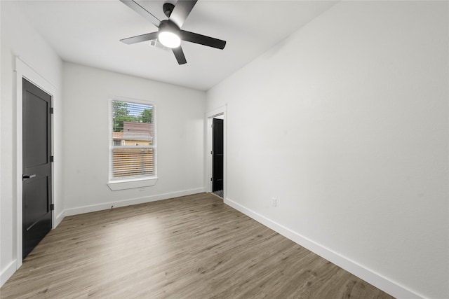 unfurnished bedroom with baseboards, a ceiling fan, and light wood finished floors