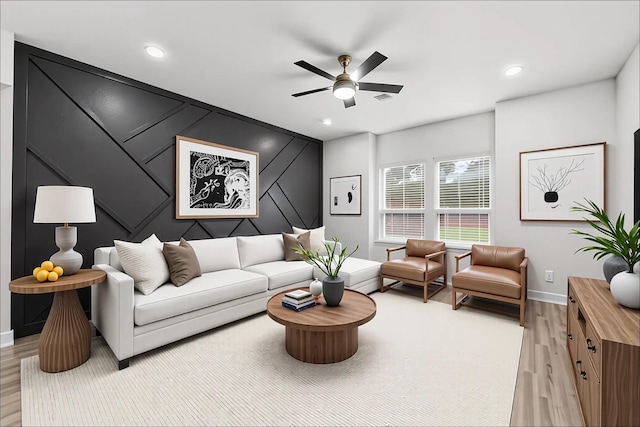 living area featuring baseboards, recessed lighting, ceiling fan, and light wood-type flooring
