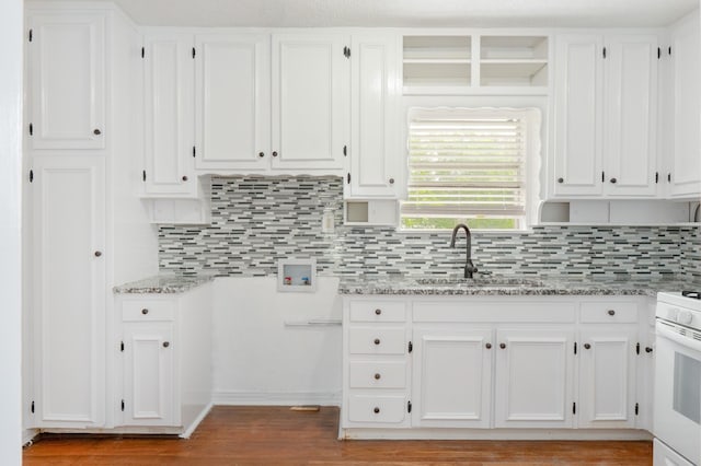 5524 Korth St, Sansom Park, TX 76114 - kitchen with white stove, a sink, white cabinetry, light stone counters, and decorative backsplash