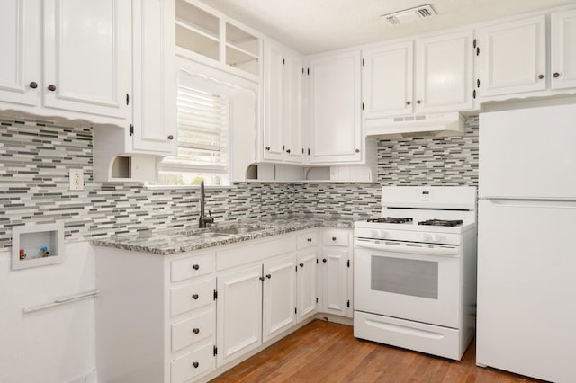 5524 Korth St, Sansom Park, TX 76114 - kitchen with white appliances, under cabinet range hood, a sink, and white cabinetry