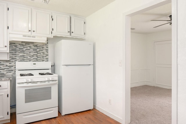5524 Korth St, Sansom Park, TX 76114 - kitchen featuring white appliances, under cabinet range hood, a ceiling fan, backsplash, and white cabinets