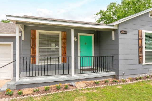 5524 Korth St, Sansom Park, TX 76114 - view of exterior entry with a porch and a garage