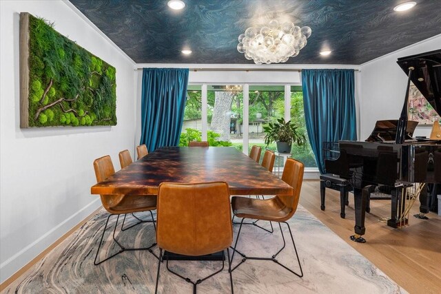 dining space with recessed lighting, baseboards, a chandelier, and wood finished floors