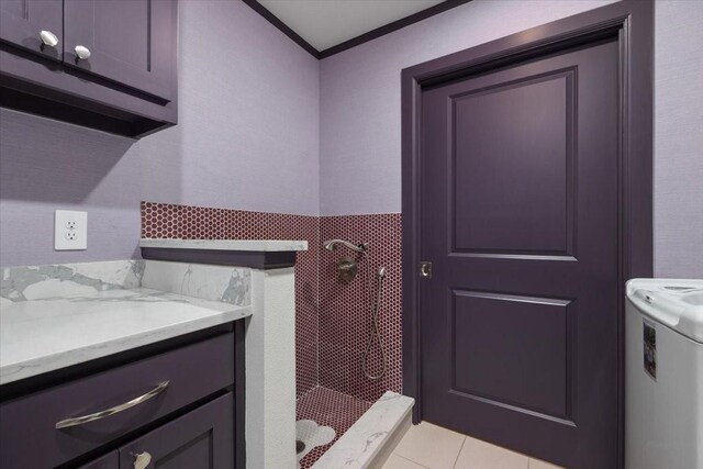 bathroom with crown molding, tile patterned flooring, and a stall shower