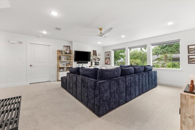 living room featuring baseboards, light carpet, recessed lighting, and visible vents