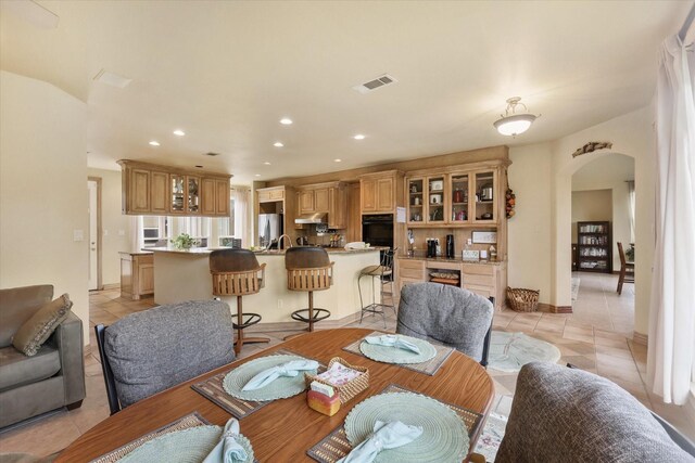 office space featuring visible vents, light tile patterned flooring, ceiling fan, recessed lighting, and a high end fireplace