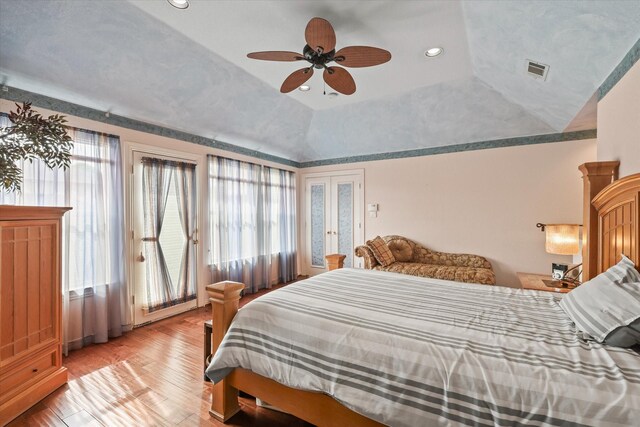 bedroom featuring visible vents, recessed lighting, lofted ceiling, and wood finished floors
