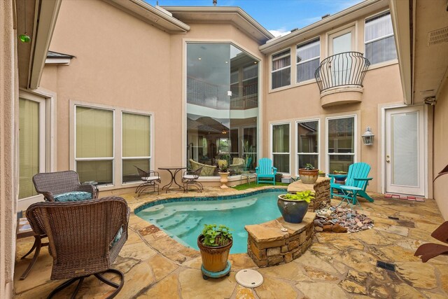 exterior space with a patio, roof with shingles, stucco siding, a fenced in pool, and a hot tub