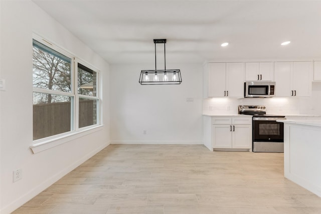 1130 Amsden Cir, Denison, TX 75020 - kitchen with light countertops, white cabinetry, appliances with stainless steel finishes, and backsplash