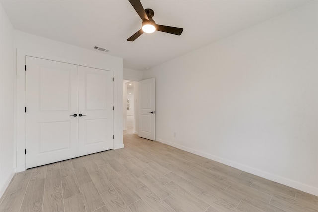 1130 Amsden Cir, Denison, TX 75020 - unfurnished bedroom featuring visible vents, a closet, baseboards, ceiling fan, and light wood finished floors