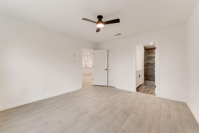 1130 Amsden Cir, Denison, TX 75020 - unfurnished bedroom with light wood finished floors, ensuite bath, a ceiling fan, baseboards, and visible vents