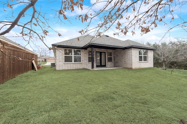 1130 Amsden Cir, Denison, TX 75020 - back of house featuring brick siding, a shingled roof, and a yard