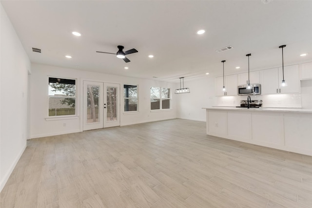 1130 Amsden Cir, Denison, TX 75020 - unfurnished living room with a sink, recessed lighting, and visible vents