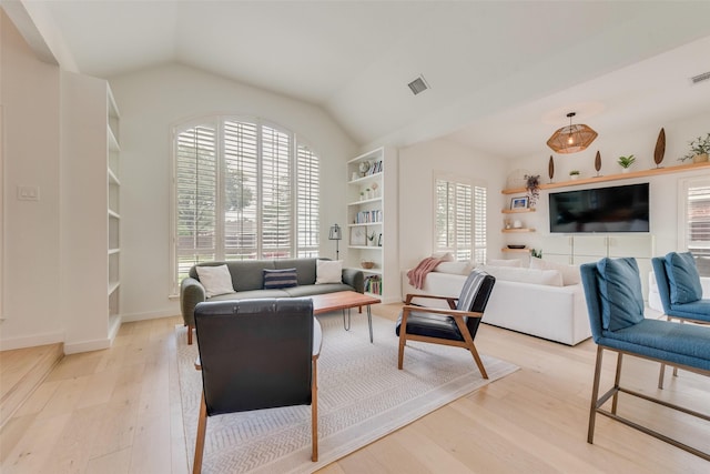 living room featuring plenty of natural light, light wood-style flooring, and visible vents