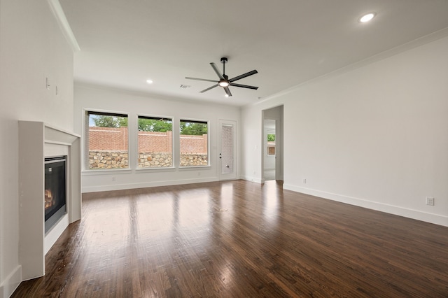 526 Windchase Dr, Haslet, TX 76052 - unfurnished living room featuring a ceiling fan, a glass covered fireplace, ornamental molding, dark wood finished floors, and baseboards