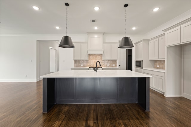526 Windchase Dr, Haslet, TX 76052 - kitchen featuring tasteful backsplash, dark wood-style flooring, a kitchen island with sink, light countertops, and recessed lighting