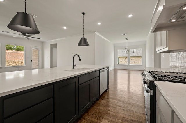 526 Windchase Dr, Haslet, TX 76052 - kitchen featuring stainless steel appliances, a sink, wall chimney range hood, dark wood-style flooring, and backsplash