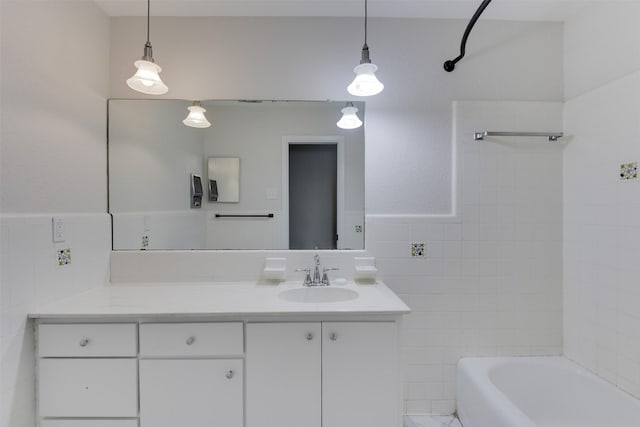 full bath featuring shower / washtub combination, tile walls, wainscoting, and vanity