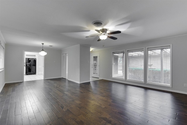 unfurnished living room with ceiling fan, ornamental molding, dark wood-style floors, and visible vents