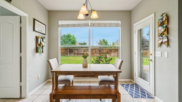 dining area with baseboards and light tile patterned flooring