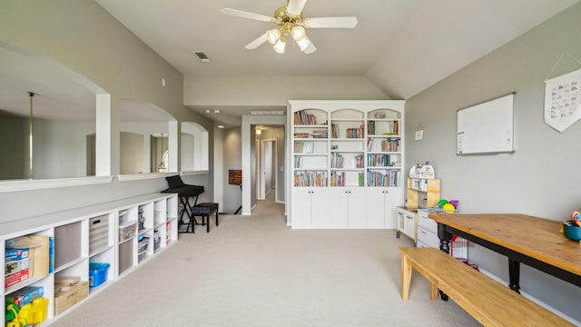 playroom with ceiling fan, visible vents, arched walkways, vaulted ceiling, and carpet floors